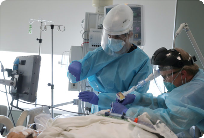 ICU clinicians attending to a mechanically ventilated patient